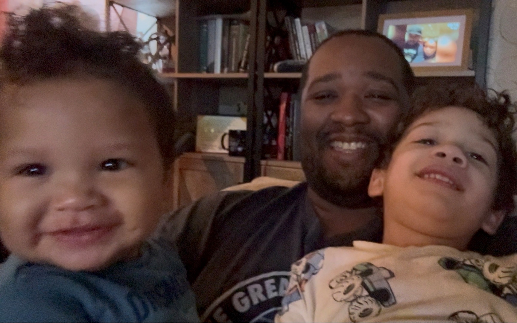 Anthony laughing with two of his sons close to the camera.