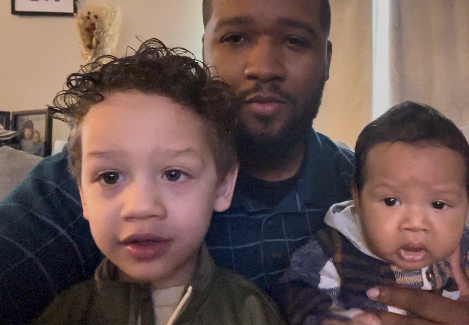 Anthony with two young children, close-up portrait.
